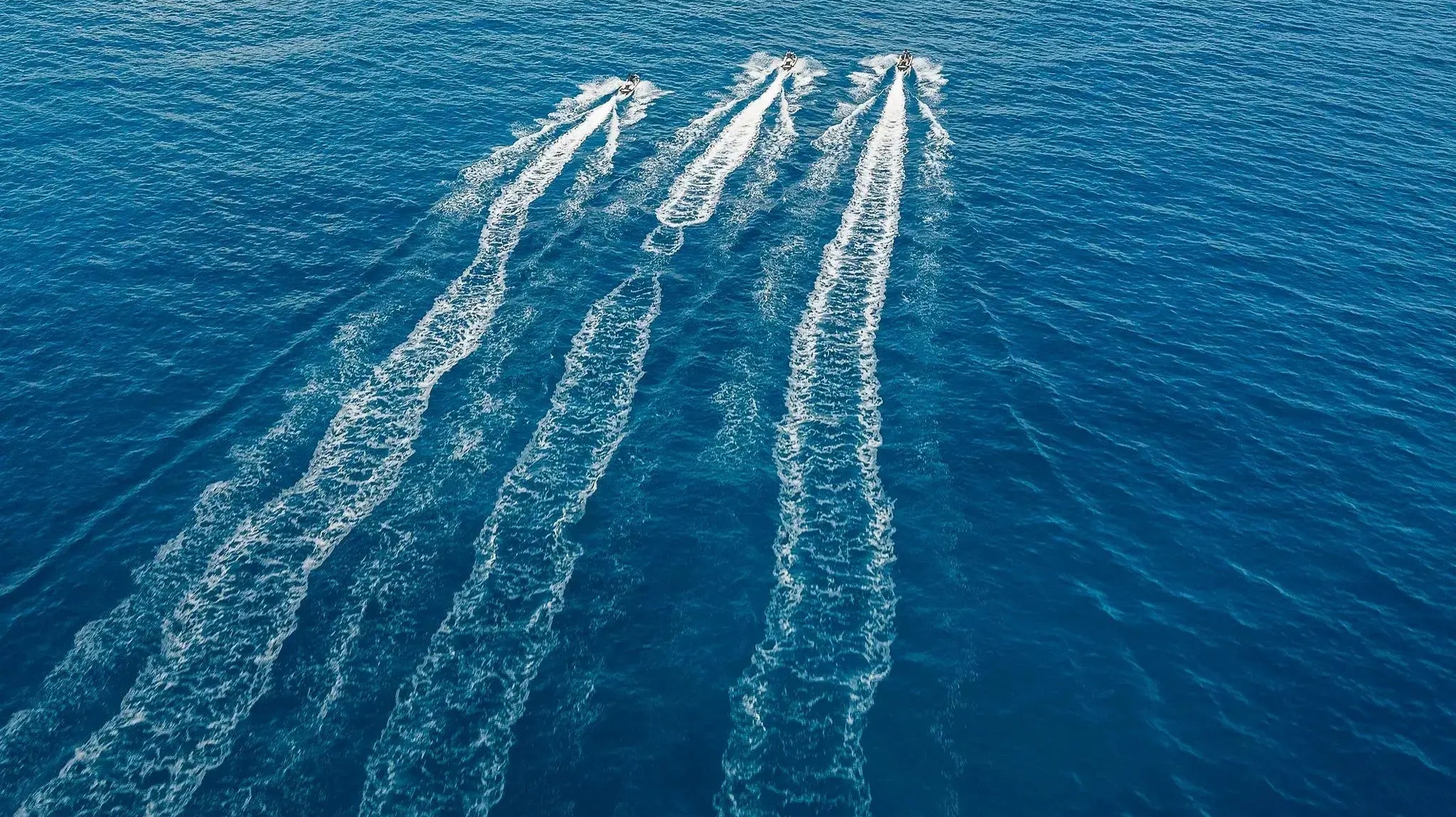 Aerial view of Sea-Doo watercraft racing in parallel across the sea off Los Cabos with Wild Canyon Adventures