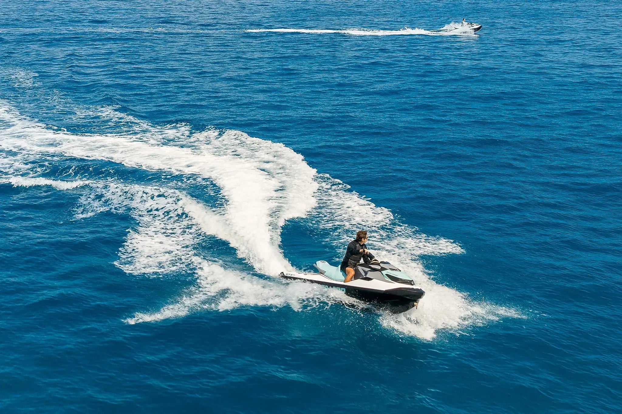 Aerial view of Sea-Doo jet skis carving across the open sea off Los Cabos, Wild Canyon Adventures