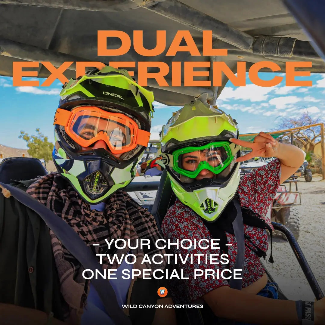 Dual Experience promo: two riders in motocross helmets and goggles in a Wild Canyon UTV, Los Cabos