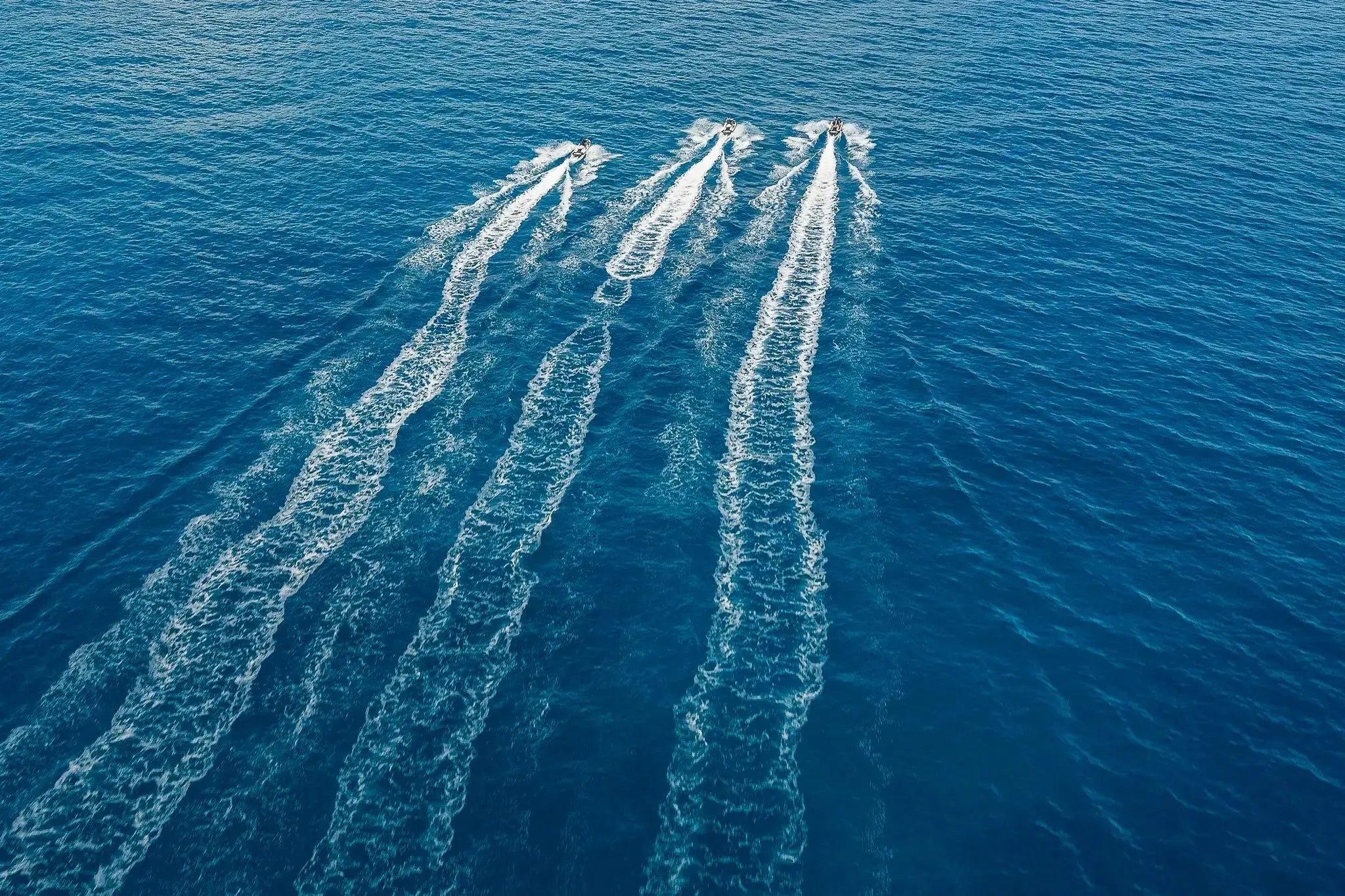 Aerial view of Sea-Doo watercraft racing in parallel across the sea off Los Cabos with Wild Canyon Adventures