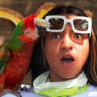 Parrot grabing a girl's sunglasses - Animal Sanctuary