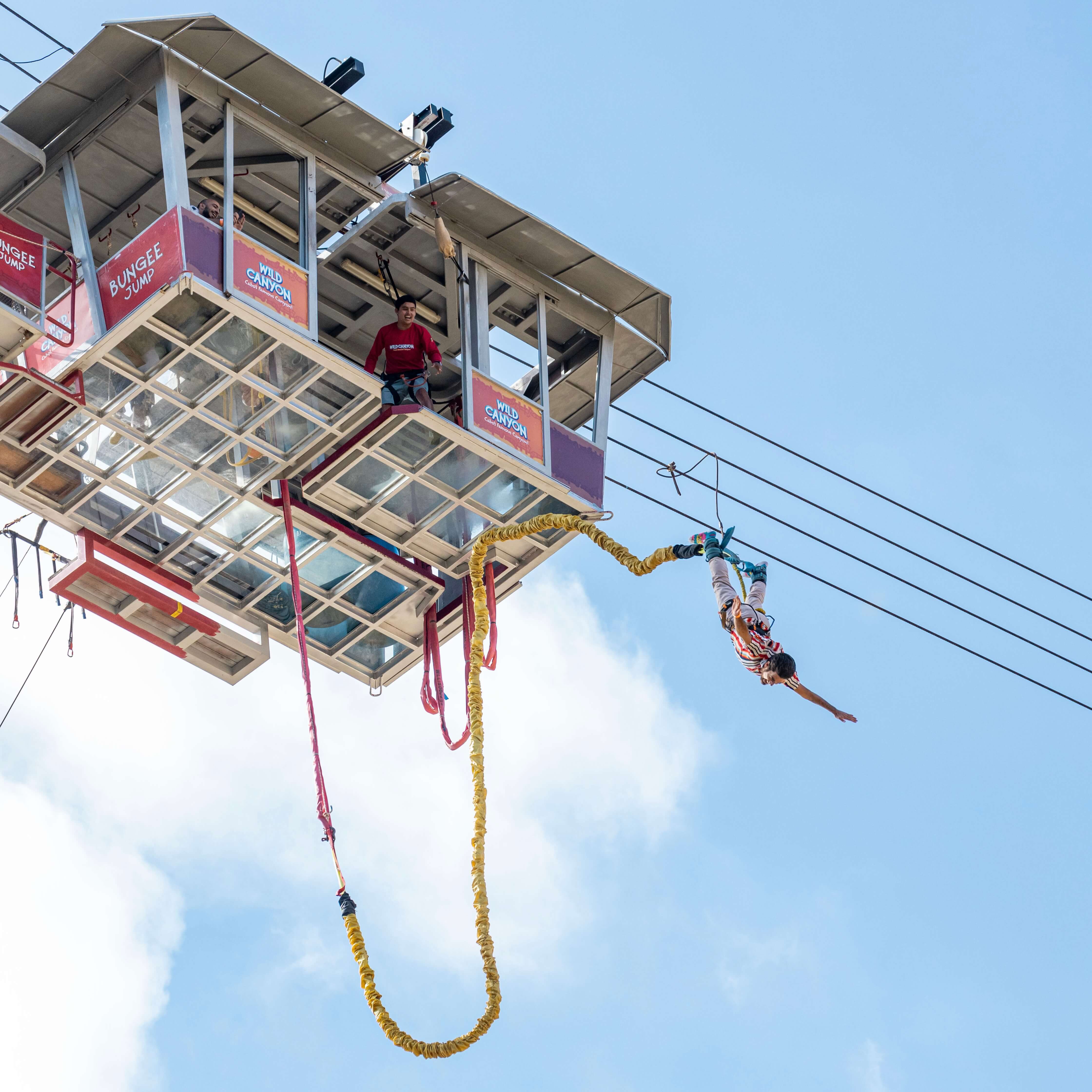 Man falling from suspended gondola in bungee jump