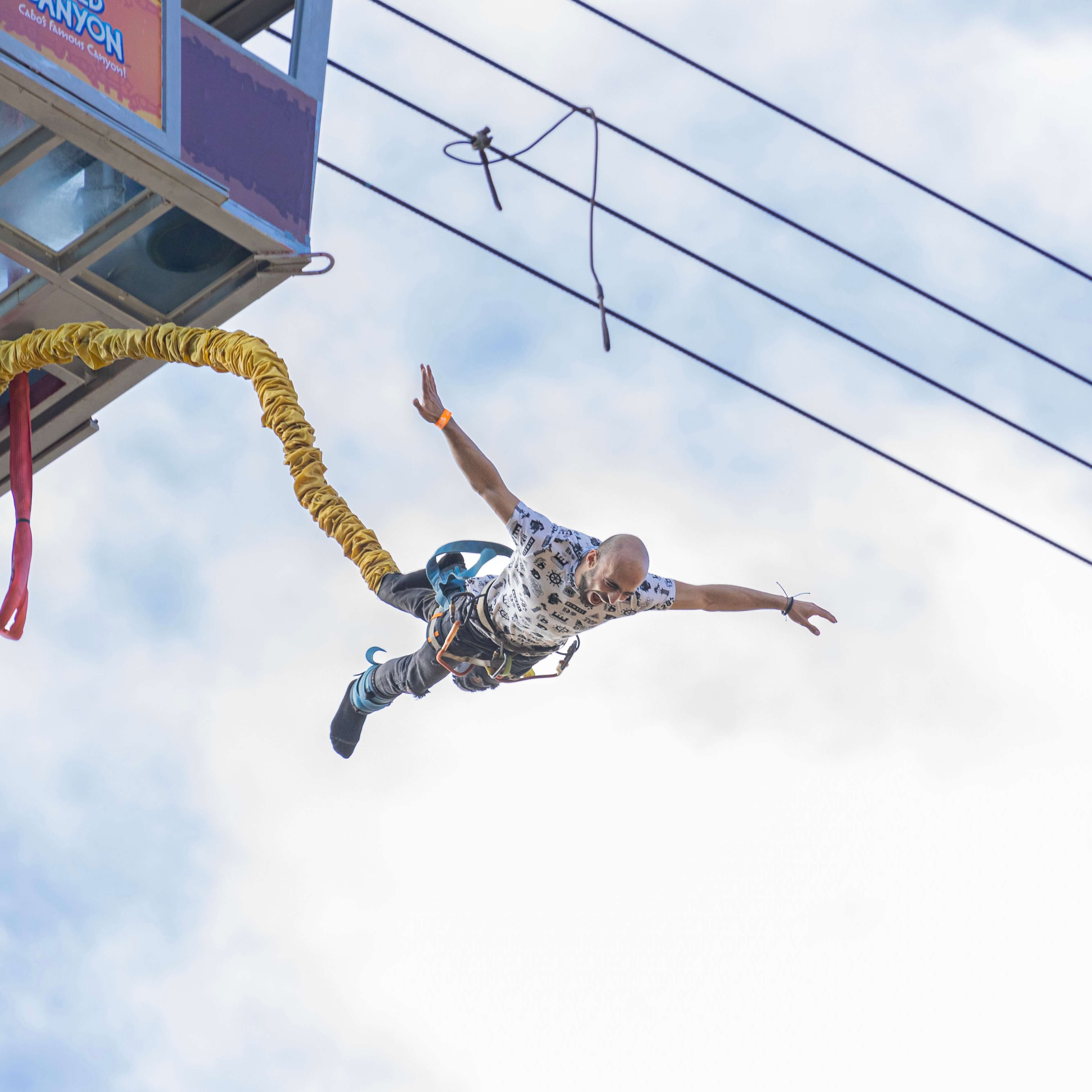 Man falling from suspended gondola in bungee jump