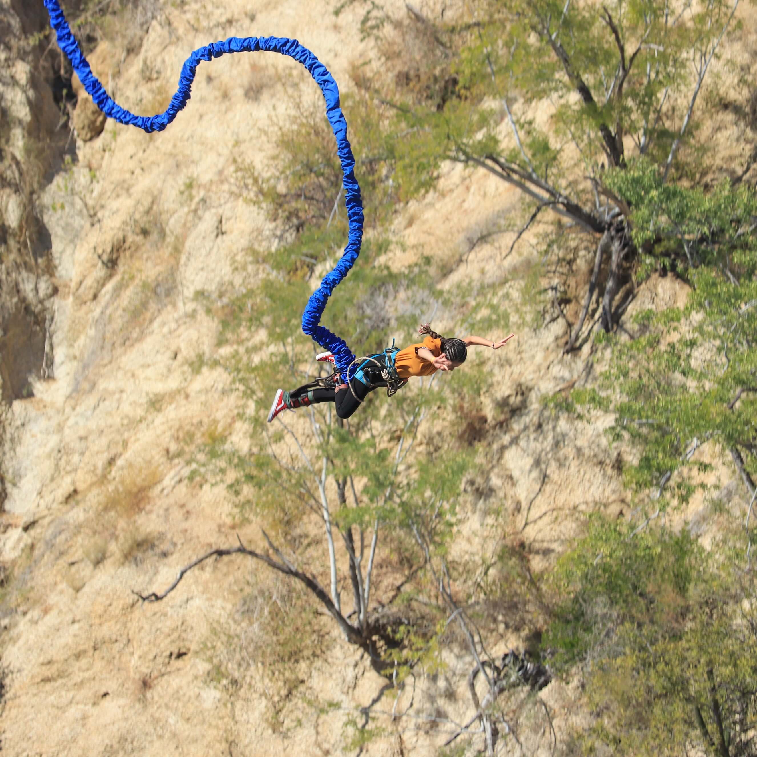 Woman falling from suspended gondola in bungee jump