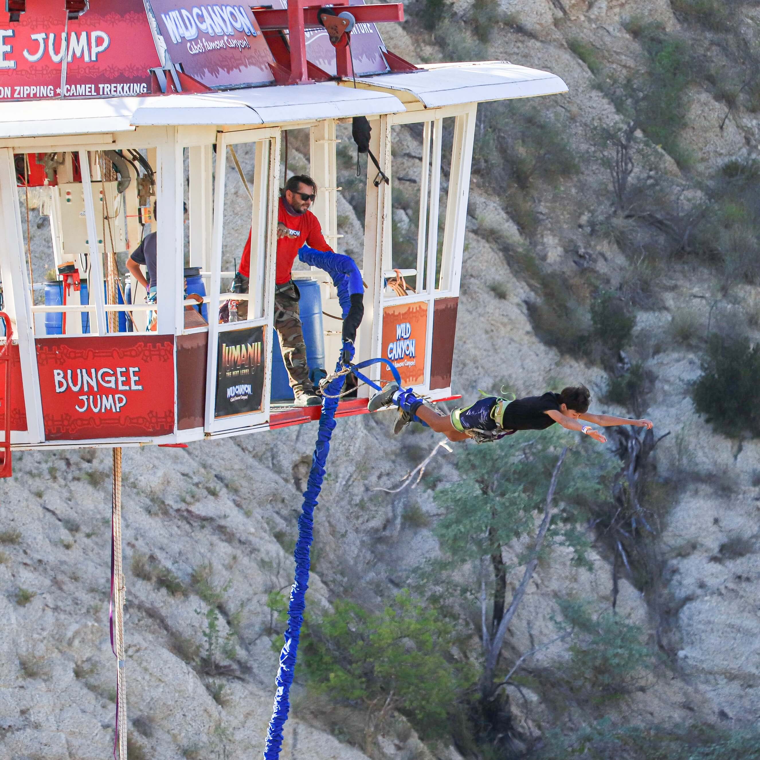 Woman falling from suspended gondola in bungee jump