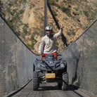 Man crossing bridge on ATV - Dual Experience