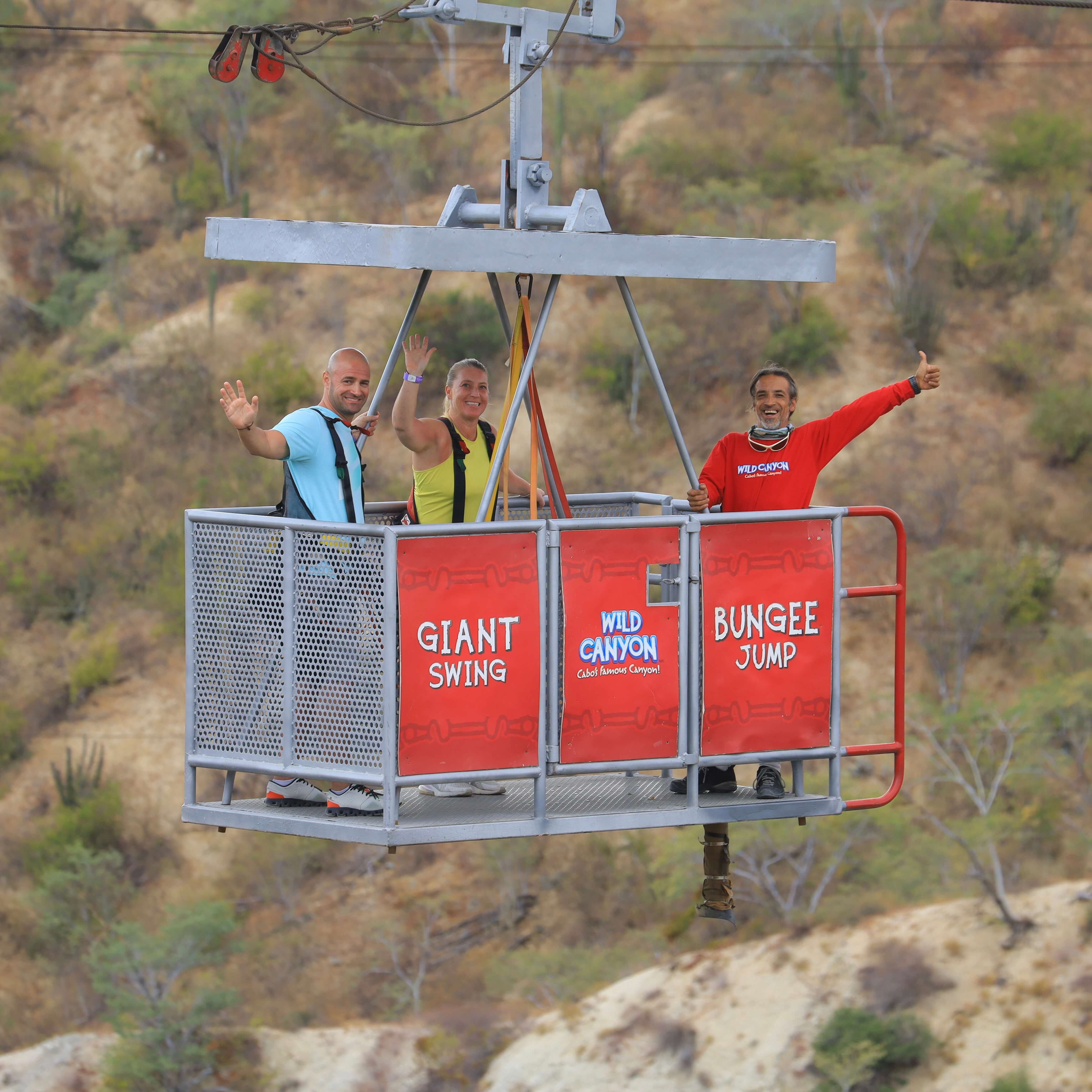 Man waving from suspended gondola