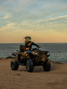 ATV rider on a Can-Am Outlander by the ocean at dusk during a Wild Canyon Adventures tour in Los Cabos