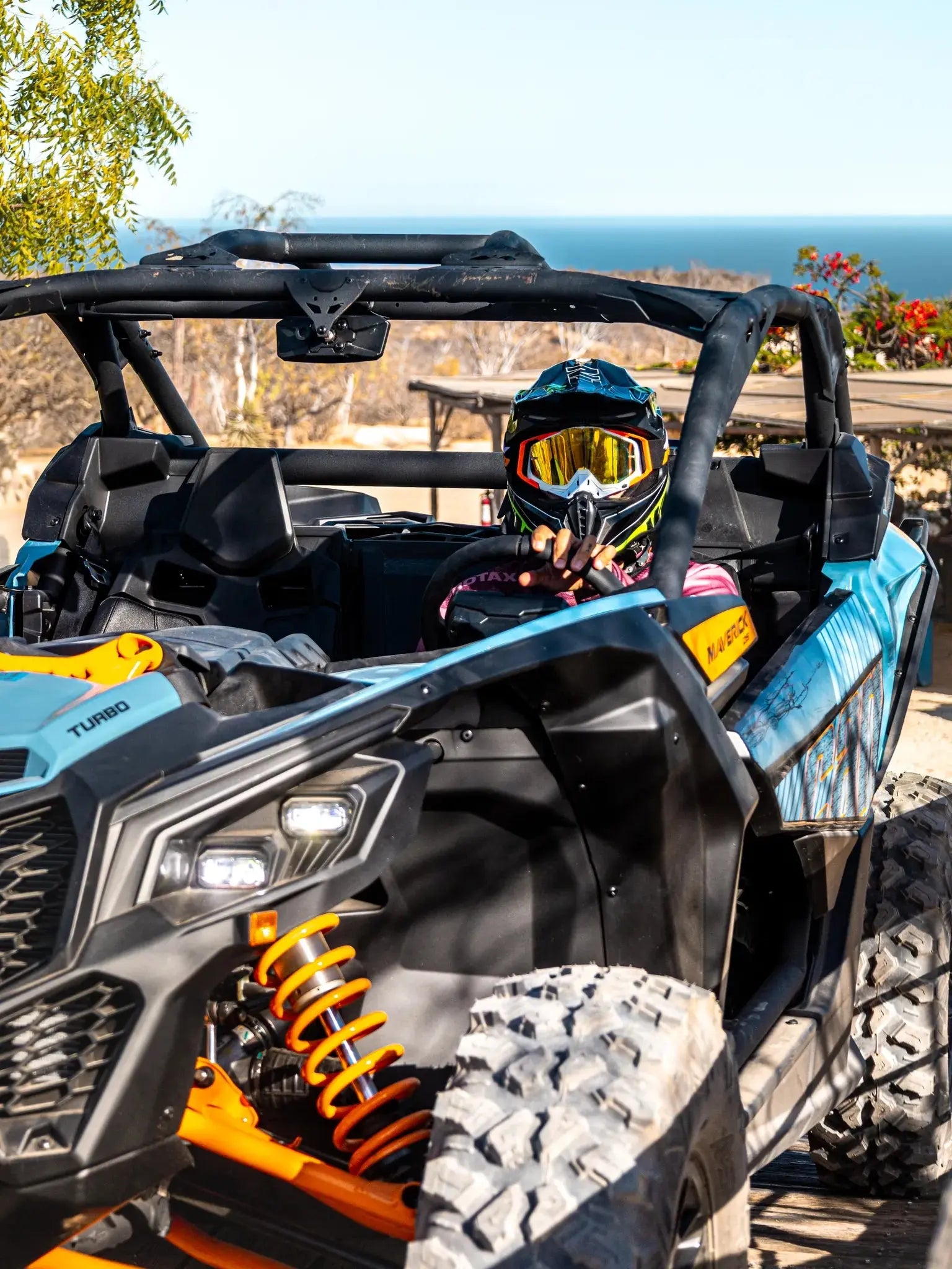 Rider in a Can-Am Maverick UTV at an ocean-view base camp at Wild Canyon Adventures in Los Cabos