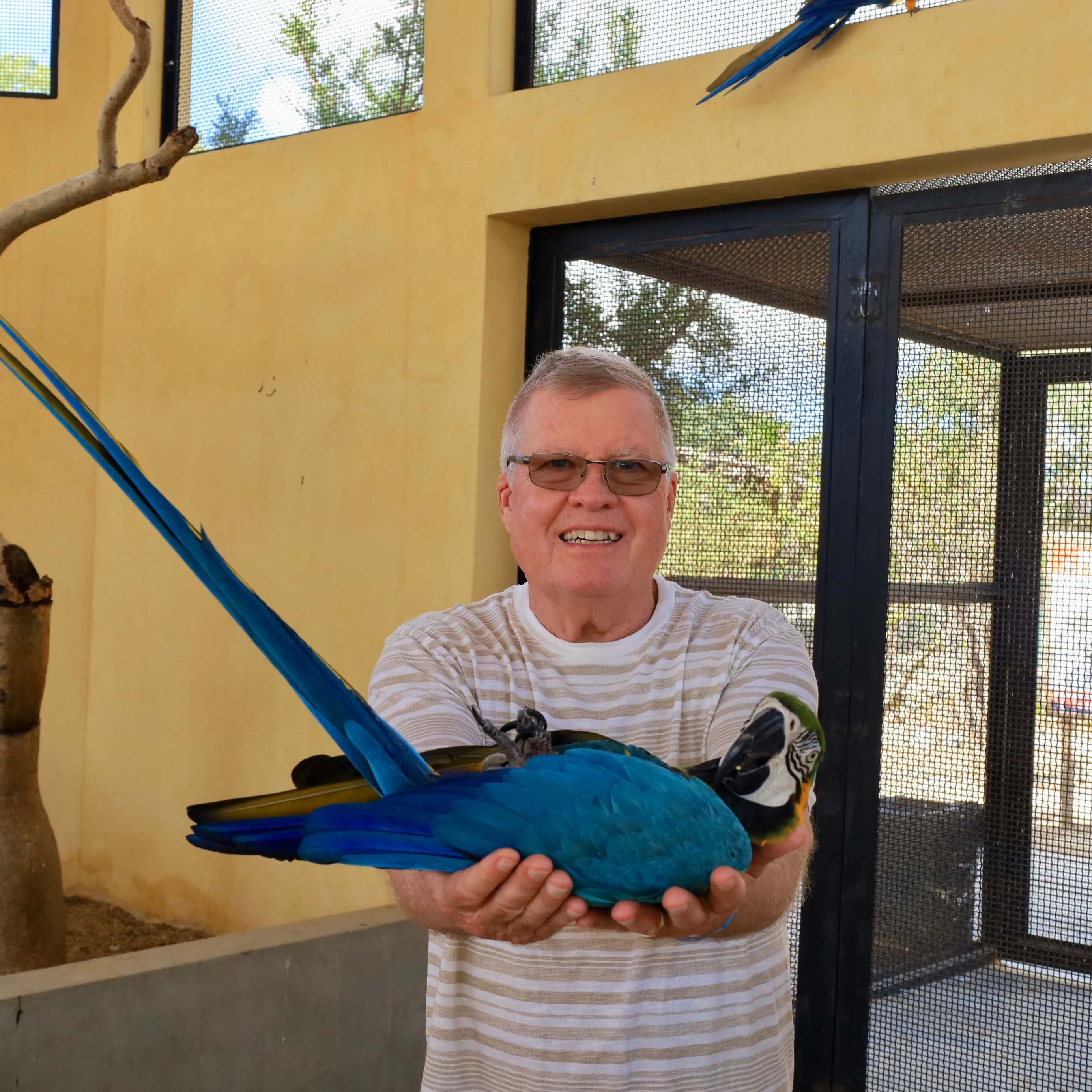 Man with blue parrot - Animal Sanctuary