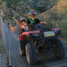 Couple on ATVs crossing hanging bridge - Wild Canyon Park Pas